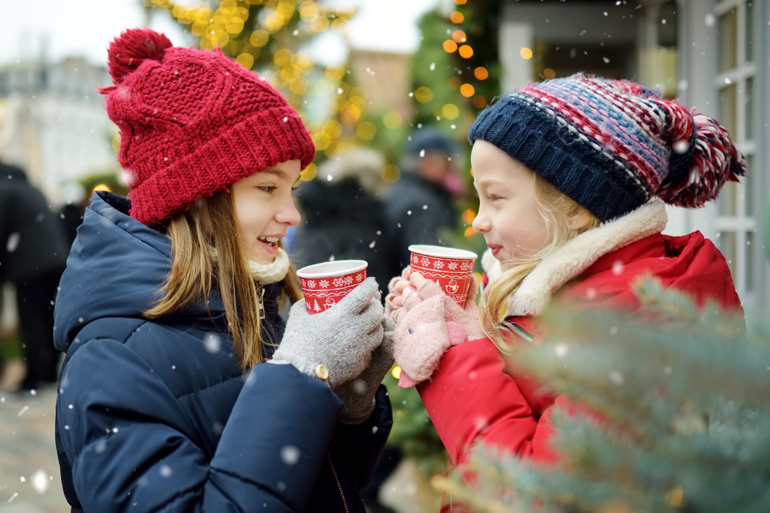 two little girls with coats, gloves and winter hats sipping hot chocolate | Natural Bridge Caverns